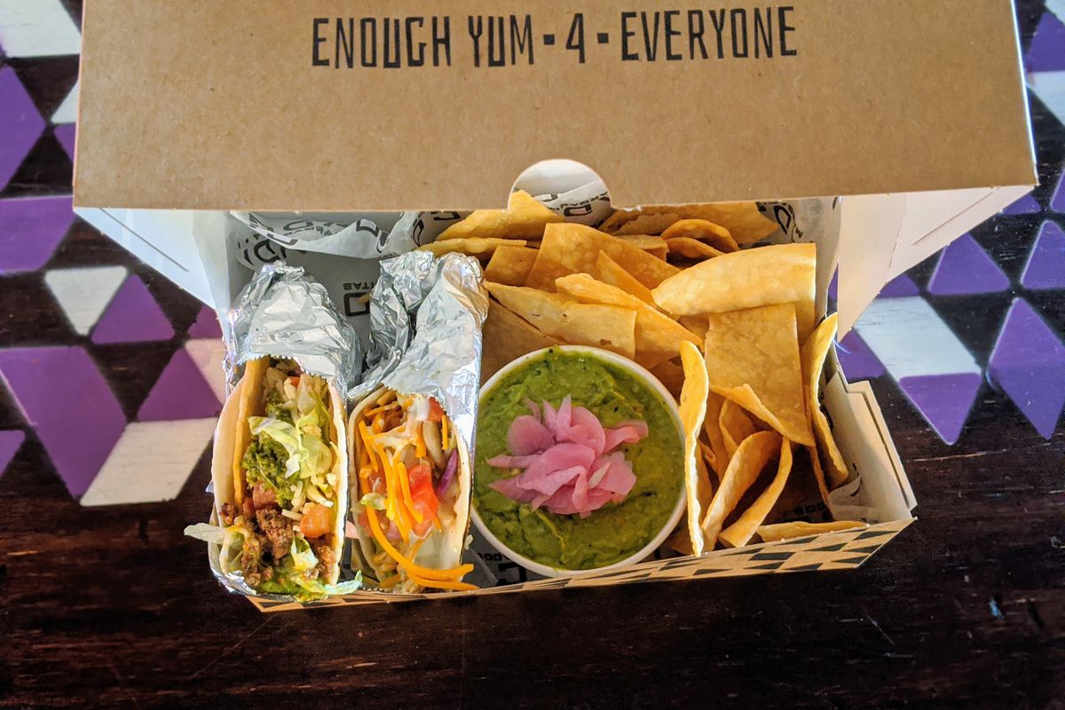 A Bud Box from Condado Tacos is filled with gaucamole, tacos, and corn chips. 