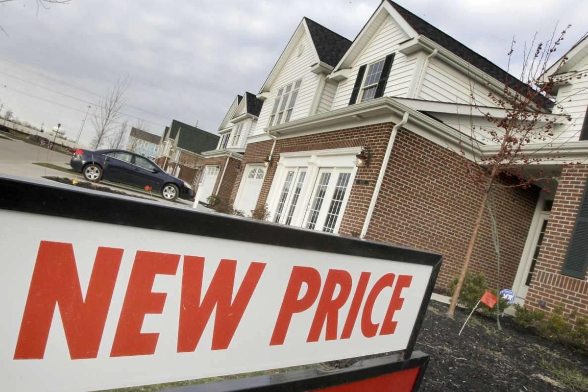 In this Januray 2011 photo, a sign shows that a new price is available on this town home for sale in in Pepper Pike, Ohio. Home prices are falling across most of America's largest cities, and average prices in eight major markets have hit their lowest poi