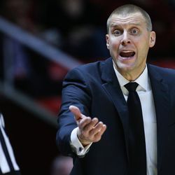 Utah Valley Wolverines head coach Mark Pope disputes an offensive foul charge during the game against the Utah Utes at the Huntsman Center in Salt Lake City on Tuesday, Dec. 6, 2016.