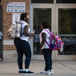 Parents and students arrive Monday at George Armstrong Elementary School in Rogers Park for the first day of school for Chicago Public Schools.