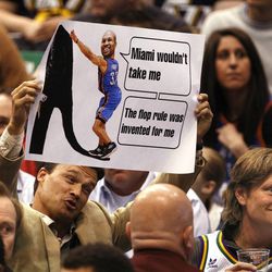 A fan flashes a sign at former Jazz member Derek Fisher as the Utah Jazz are defeated by the Oklahoma City Thunder 90-80 as they play NBA basketball Tuesday, April 9, 2013, in Salt Lake City.