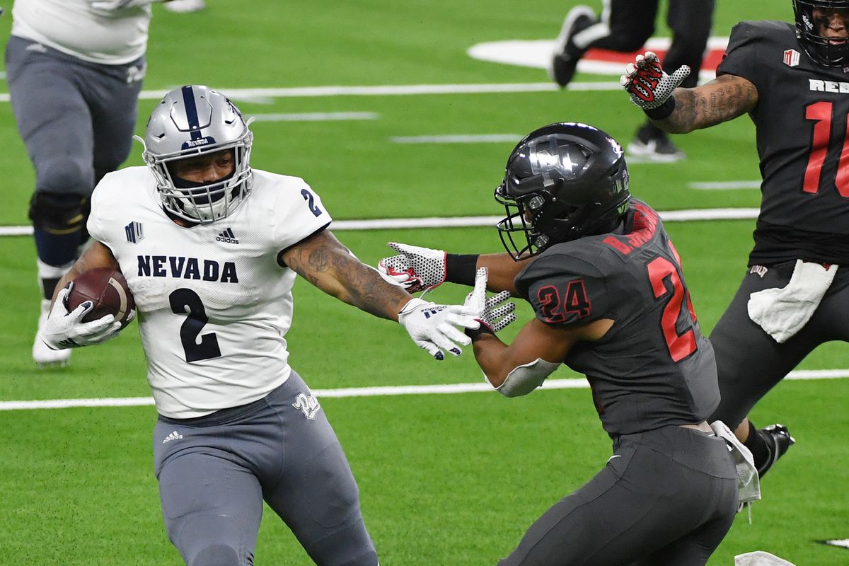 Running back Devonte Lee of the Nevada Wolf Pack runs against defensive back Bryce Jackson of the UNLV Rebels for a 35-yard gain in the second half of their game at Allegiant Stadium on October 31, 2020 in Las Vegas, Nevada. The Wolf Pack defeated the Rebels 37-19.