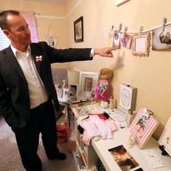 Tony Parks, who has lost two daughters, one to stillbirth and one shortly after birth, points to photos that decorate the girls' room at home in West Valley City on Monday, Nov. 21, 2016.