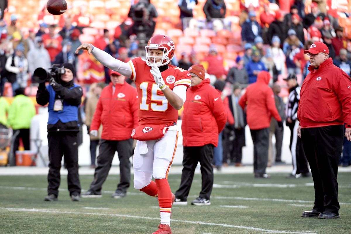 Kansas City Chiefs quarterback Patrick Mahomes warms up as head coach Andy Reid watches before the game against the Tennessee Titans in the AFC Wild Card playoff football game at Arrowhead stadium.