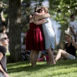 Two women embrace during a vigil for Mackenzie Lueck, a University of Utah student believed to have been murdered, on the University of Utah Union lawn in Salt Lake City on Monday, July 1, 2019.