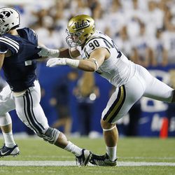 Brigham Young Cougars quarterback Taysom Hill (7) is sacked by UCLA Bruins defensive lineman Rick Wade (90)  in Provo on Saturday, Sept. 17, 2016.
