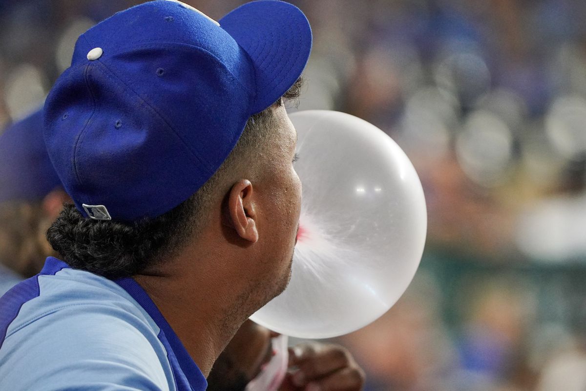 Kansas City Royals relief pitcher Carlos Hernandez (43) blows a large bubble while watching from the dugout against the Seattle Mariners in the ninth inning at Kauffman Stadium. 