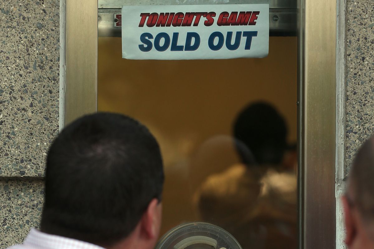 CHICAGO, IL - JUNE 15: A sign which reads "Tonight's Game Sold Out" as fans stand outside the ticket window prior to Game Two of the NHL 2013 Stanley Cup Final between the Chicago Blackhawks and the Boston Bruins at United Center on June 15, 2013.