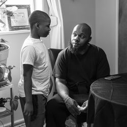 Nathan Wallace Jr., 29, sits at the kitchen table at his brother’s Far South Side home and chats with his 8-year-old son, Nathan Wallace III, Thursday afternoon, Aug. 6, 2020. Nathan Wallace Jr.’s 7-year-old daughter, Natalia Wallace was killed in a Fourth of July shooting while she was playing on the sidewalk outside her grandmother’s house during a family holiday party in the 100 block of North Latrobe Avenue in Austin. Three men have been charged in connection with the homicide.