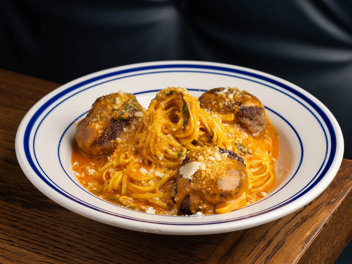 Capellini and meatballs at Jemma di Mare in Brentwood.  An orange-red sauce with spaghetti and meatballs on a blue-ringed white plate at a new restaurant.