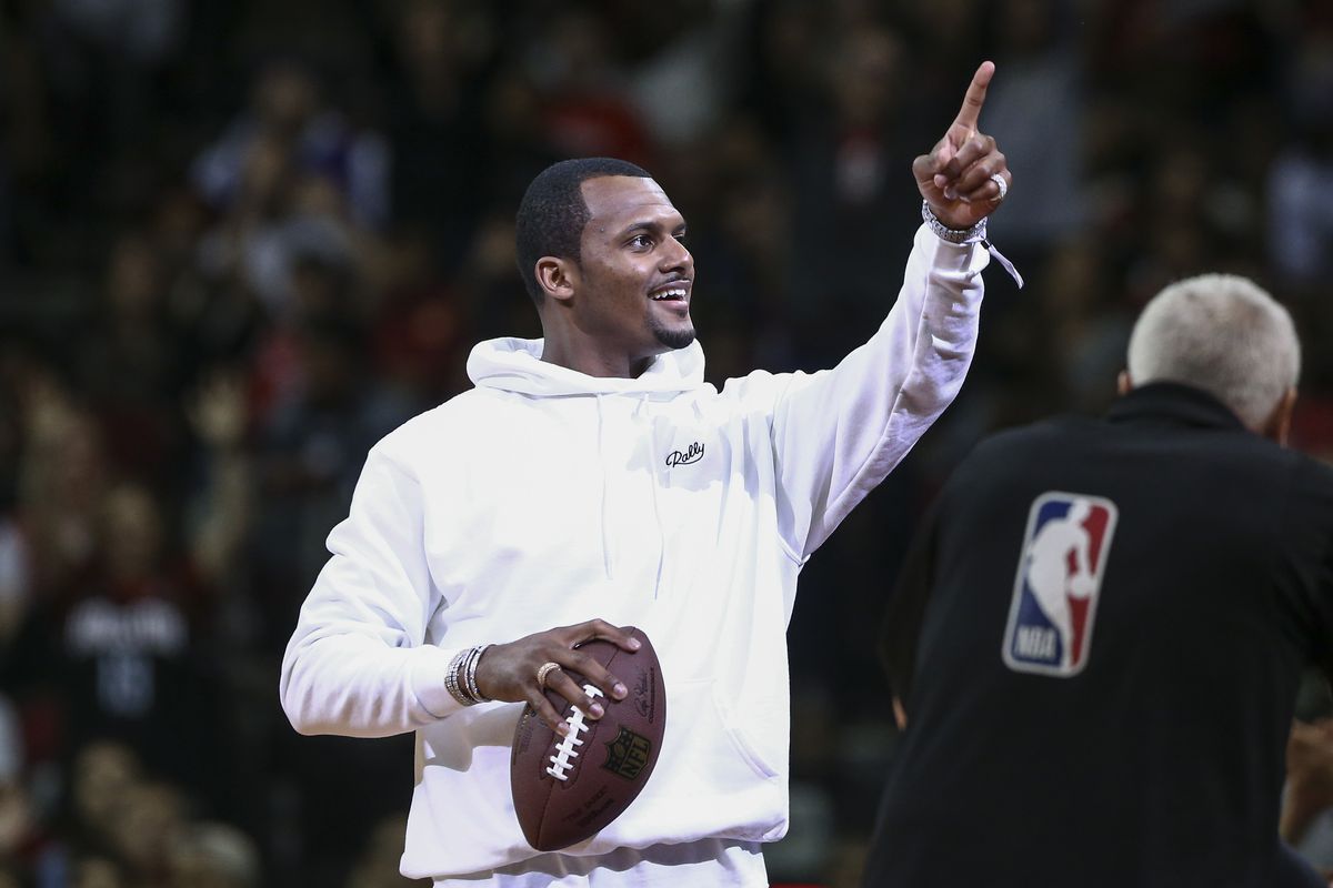 Houston Texans quarterback Deshaun Watson throws a football into the crowd during the game between the Houston Rockets and the New Orleans Pelicans at Toyota Center.