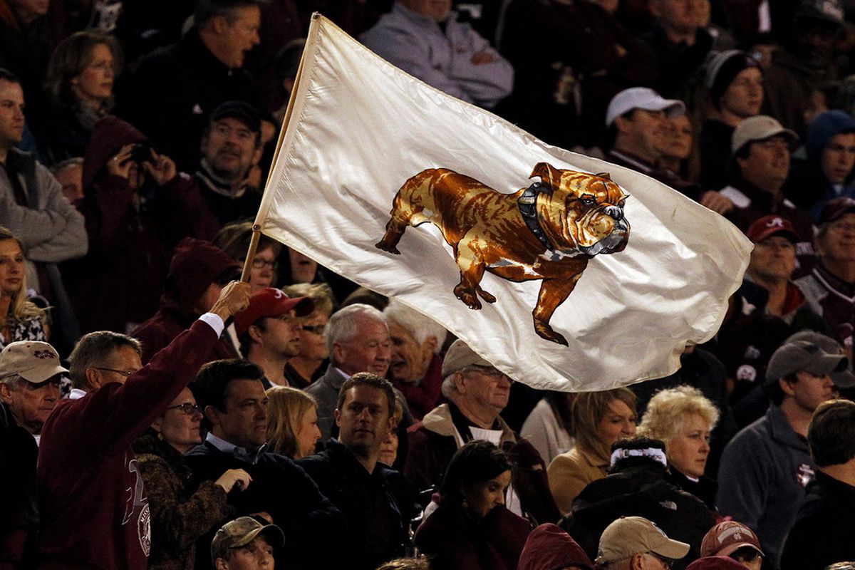 STARKVILLE, MS - NOVEMBER 12:  A Mississippi State Bulldogs fan waves a flag during the game against the Alabama Crimson Tide on November 12, 2011 at Davis Wade Stadium in Starkville, Mississippi. (Photo by Butch Dill/Getty Images)