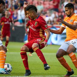 Real Salt Lake midfielder Luis Silva (20), center, and Houston Dynamo midfielder Juan David Cabezas (5) and defender Leonardo (22) compete for the ball during a match at Rio Tinto Stadium in Sandy on Saturday, Aug. 5, 2017.