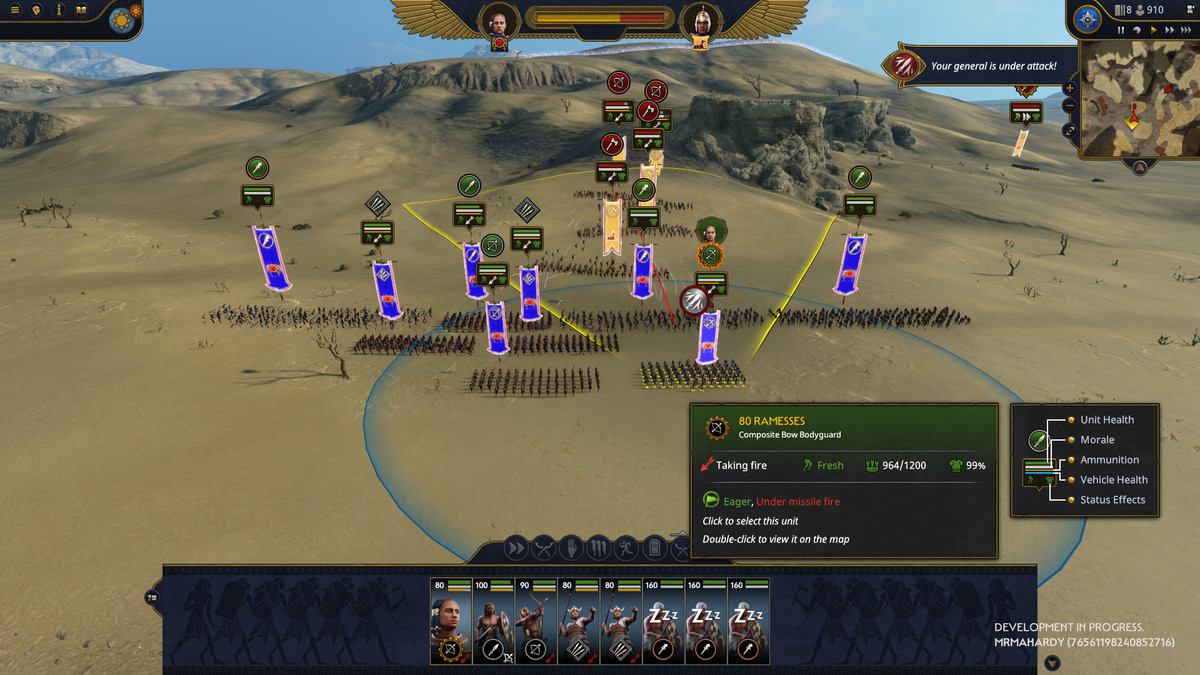 A battle players out in the desert in Total War: Pharaoh, with Hittites streaming down a hill toward Egyptian forces