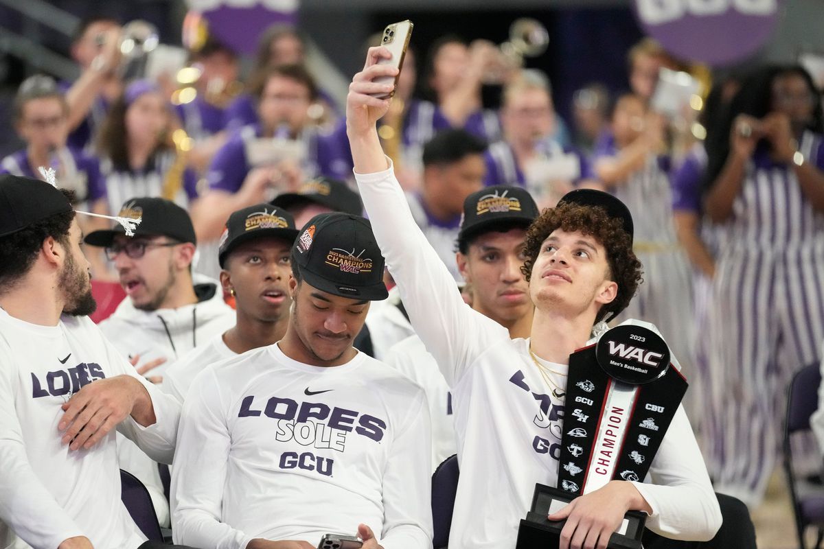Grand Canyon guard Walter Ellis takes a photo during an NCAA Selection Show watch party at GCU Arena on March 12, 2023.