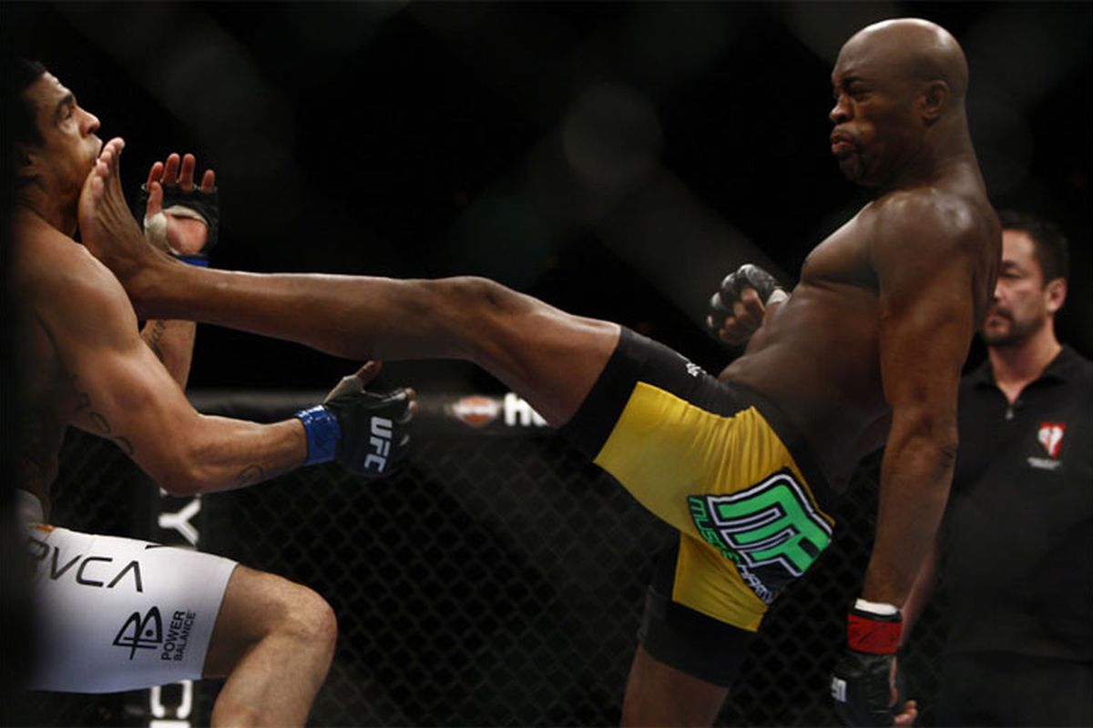 Anderson Silva crushes Vitor Belfort with a front kick at UFC 126. (Photo by Esther Lin via MMA Fighting)