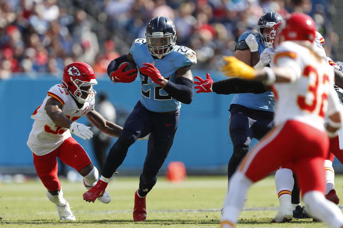 Derrick Henry #22 of the Tennessee Titans runs with the ball while being chased by Charvarius Ward #35 of the Kansas City Chiefs in the first quarter in the game at Nissan Stadium on October 24, 2021 in Nashville, Tennessee.