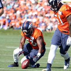 Broncos LBs Steven Johnson falls on the ball after a Todd Davis sideline tip in loose ball drills