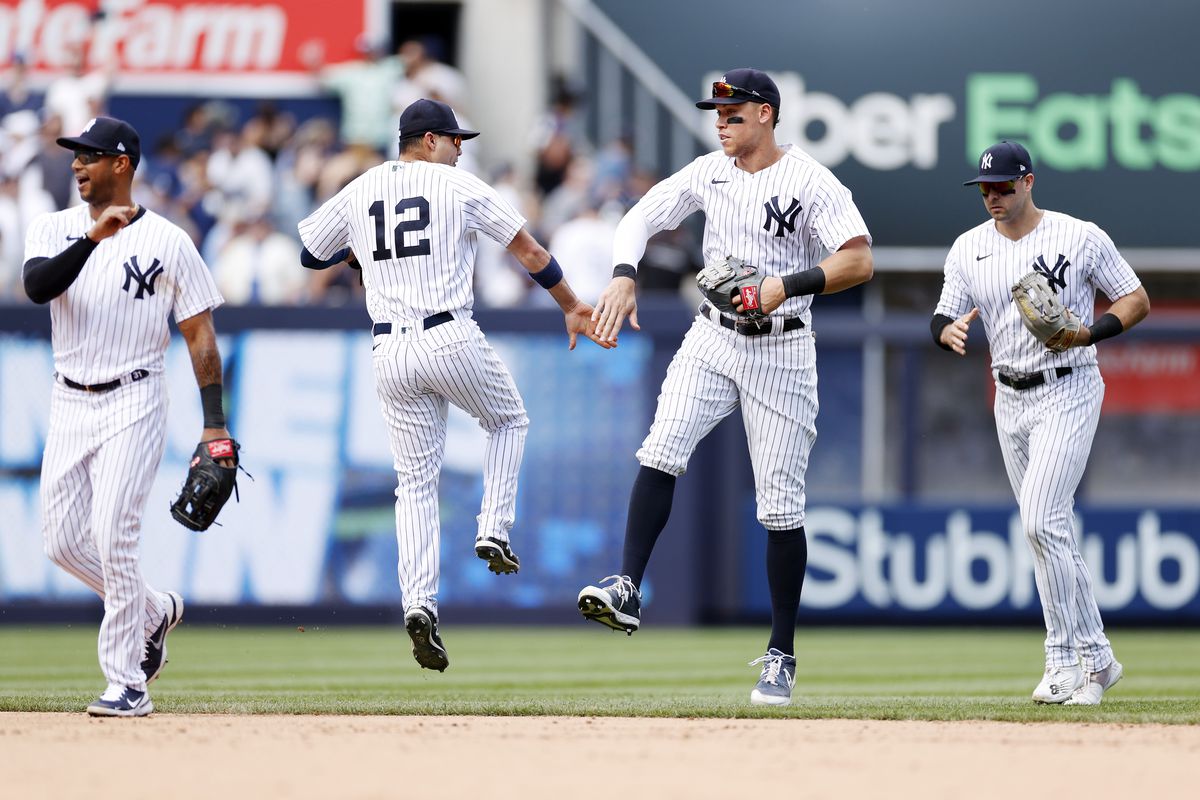 Aaron Hicks #31, Isiah Kiner-Falefa #12, Aaron Judge #99, and Joey Gallo #13 of the New York Yankees celebrate during the ninth inning against the Detroit Tigers at Yankee Stadium on June 04, 2022 in the Bronx borough of New York City. The Yankees won 3-0.