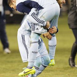 Kansas City's Graham Zusi picks up teammate Benny Feilhaber as they celebrate their win over Real Salt Lake Saturday, Dec. 7, 2013 in MLS Cup action.