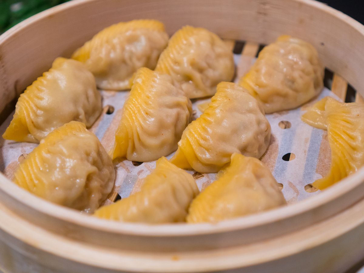 Kimchi dumplings sit in a steamer basket at Din Tai Fung