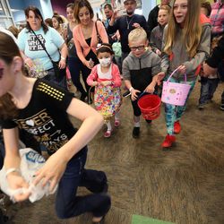 Children run for eggs at the start of Make-A-Wish Utah's annual Easter egg hunt for children facing life-threatening medical conditions at the Discovery Gateway Museum in Salt Lake City on Saturday, March 19, 2016. 
