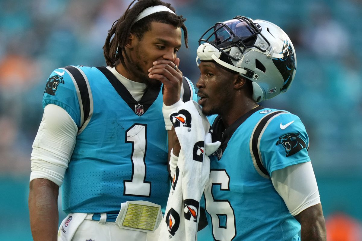 Carolina Panthers quarterback Cam Newton (1) talks with quarterback P.J. Walker (6) during a time out in the second half against the Miami Dolphins at Hard Rock Stadium.