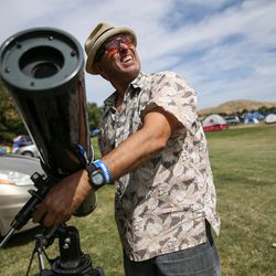 Eric Wheeler, of Roseville, Calif., sets up his telescope as he and his wife, Lisa, prepare for Monday's total solar eclipse at Weiser High School in Weiser, Idaho, on Sunday, Aug. 20, 2017.