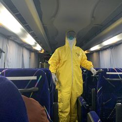 A masked worker walks through a bus transporting Mark Jorgensen and others who contracted COVID-19 while on a cruise in Japan in early 2020. Jorgensen’s wife, Jerri, also contracted COVID-19. Mark Jorgensen was flown back to the U.S. directly to an Air Force base in California before being transferred to Intermountain Medical Center in Murray.