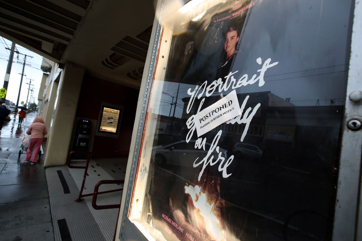 A postponed sign is displayed on a movie poster at Balboa Theater.