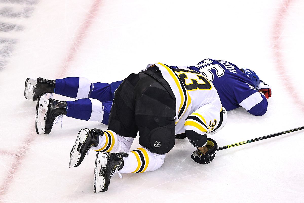 Nikita Kucherov of the Tampa Bay Lightning lays on the ice after sustaining an injury on a high-sticking penalty by Zdeno Chara of the Boston Bruins during the first period in Game Five of the Eastern Conference Second Round during the 2020 NHL Stanley Cup Playoffs at Scotiabank Arena on August 31, 2020 in Toronto, Ontario.