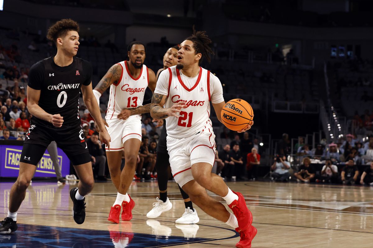 Houston Cougars guard Emanual Sharp dribbles past Cincinnati Bearcats guard Dan Skillings Jr. during the semifinal game of the American Athletic Conference Tournament at the Dickies Arena in Forth Worth, TX on March 11, 2023.