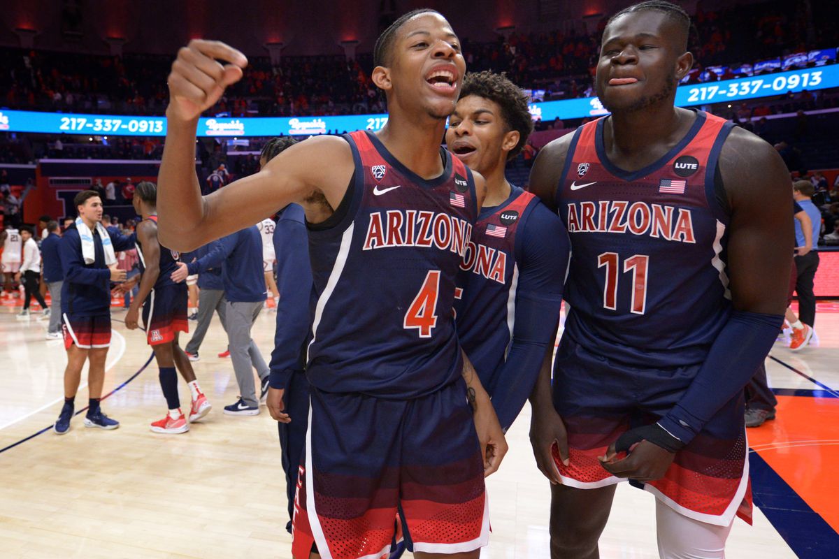Arizona Wildcats players celebrate their team s 83-79 win over the Illinois fighting Illini at State Farm Center.