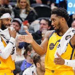 Utah Jazz guard Mike Conley, left, laughs while conversing with Utah Jazz guard Donovan Mitchell during an NBA game against Portland Trail Blazers at Vivint Arena in Salt Lake City on Monday, Nov. 29, 2021.