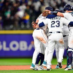 Ty France #23 and Cal Raleigh #29 of the Seattle Mariners celebrate with teammates after the Mariners defeated the Cleveland Guardians at T-Mobile Park on Thursday, March 30, 2023 in Seattle, Washington.