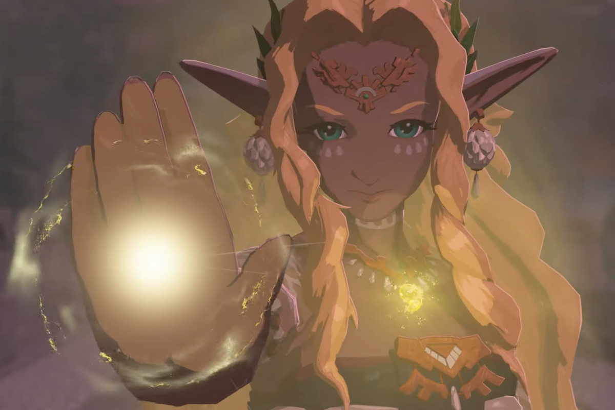 An image of an elf-like character from The Legend of Zelda: Tears of the Kingdom. They have long hair and long pointy ears. Their hand is glowing yellow and so is their necklace as they looked determined into the camera.