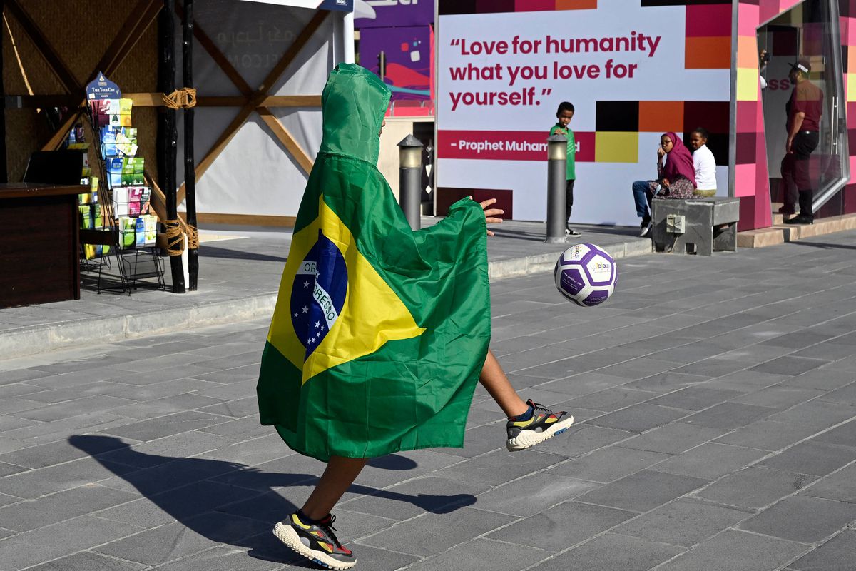 A supporter of Brazil shoots a ball in Doha on November 24, 2022, during the Qatar 2022 World Cup football tournament.