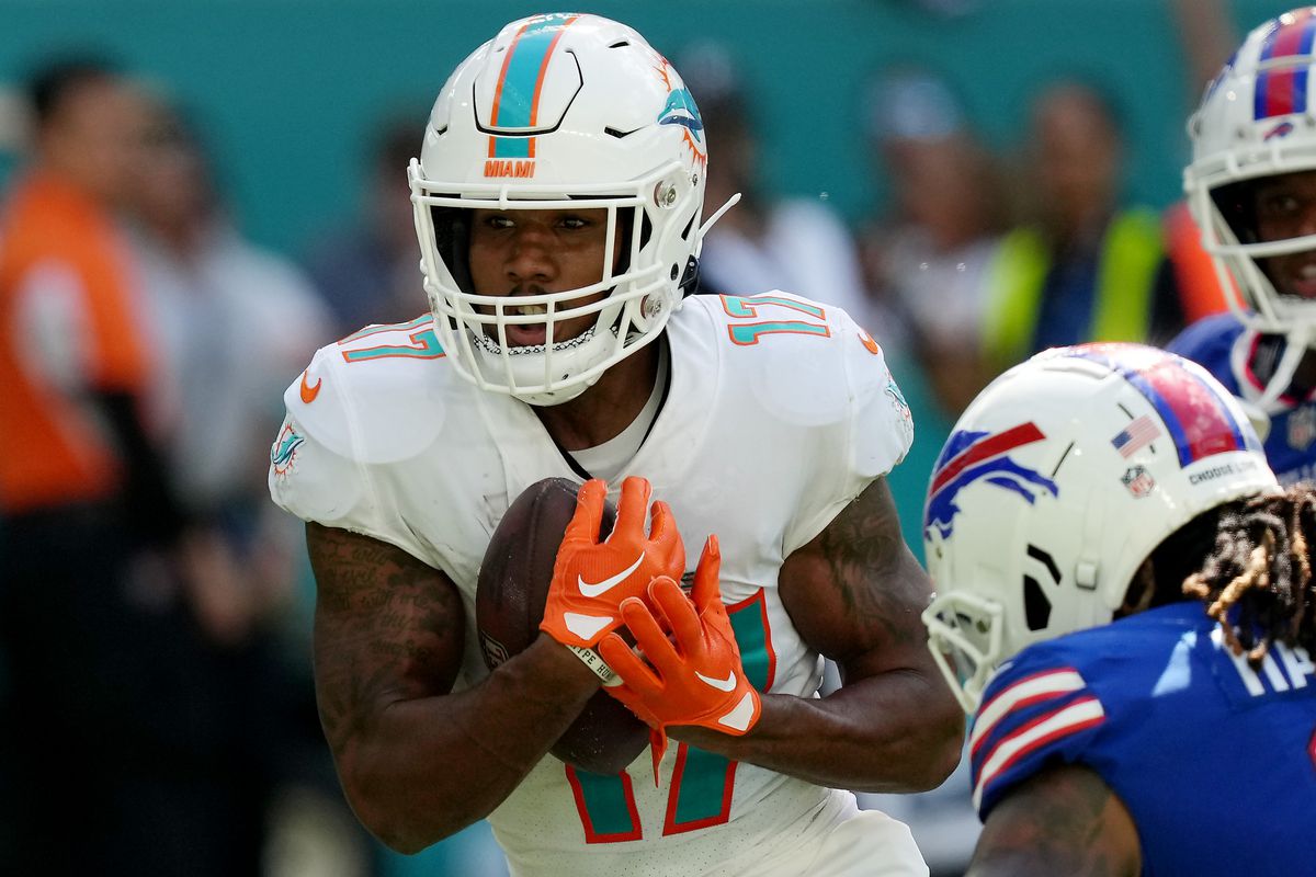 Wide receiver Jaylen Waddle #17 of the Miami Dolphins is tackled by safety Damar Hamlin #3 of the Buffalo Bills after he catches the ball in the third quarter of the game at Hard Rock Stadium on September 25, 2022 in Miami Gardens, Florida.