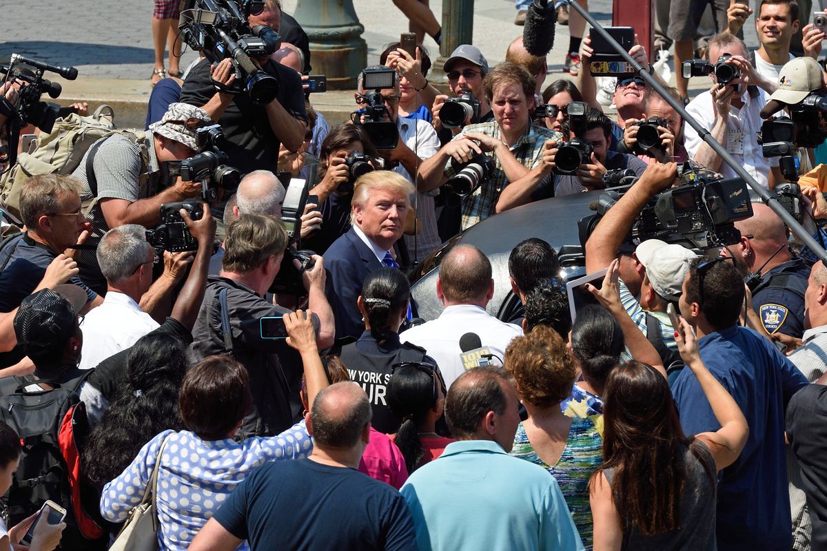Donald Trump is mobbed by the media as he exits New York Supreme Court after morning jury duty August 17, 2015