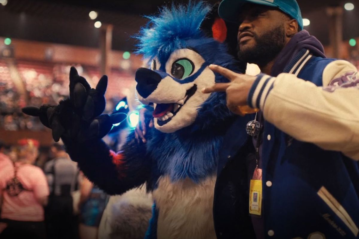 Dominique&nbsp;“SonicFox” McLean (left), wearing their full fur suit, poses with a concert-goer (right) at a Lil Nax X concert