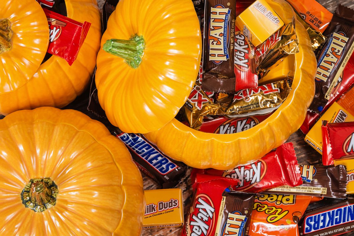 Decorative pumpkins filled with assorted Halloween chocolate candy made by Mars, Incorporated and the Hershey Company. 