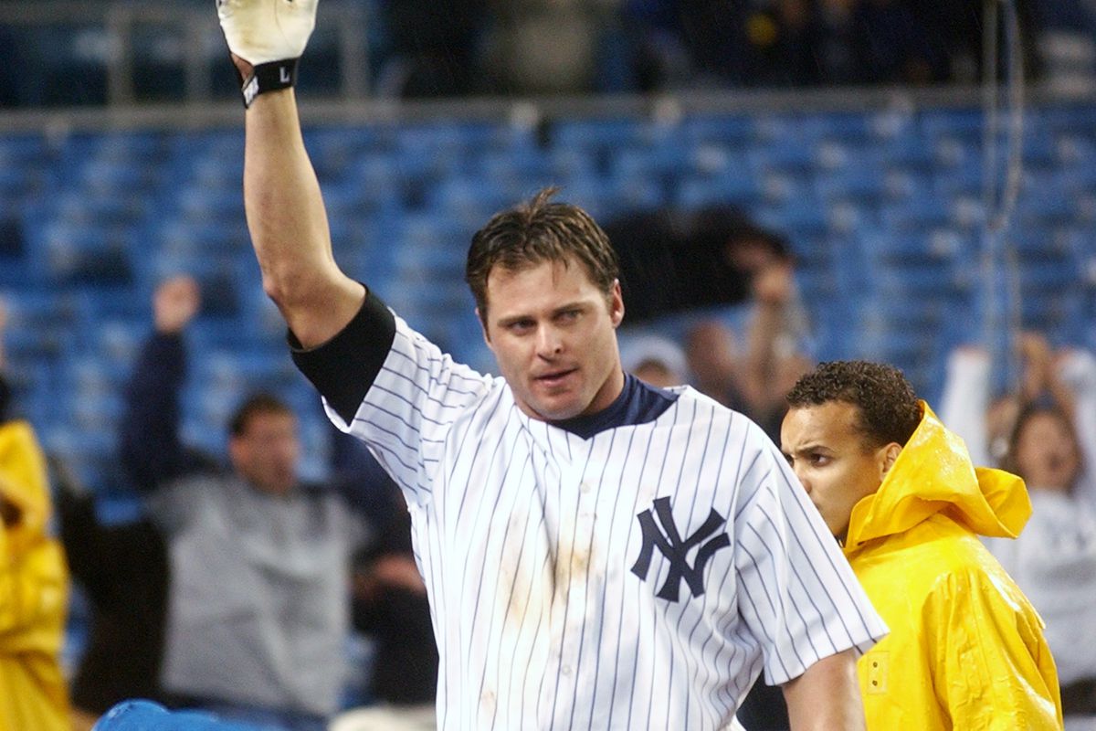 New York Yankees’ Jason Giambi waves to cheering crowd after