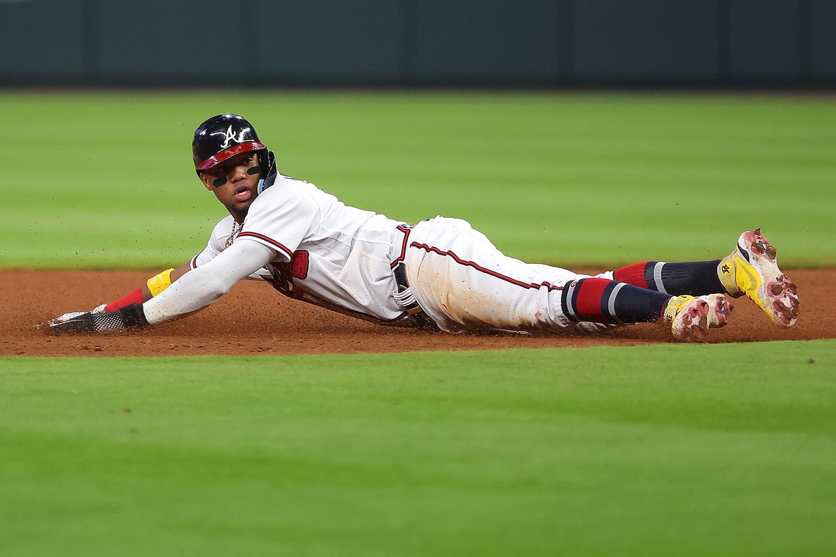 Ronald Acuna Jr. #13 of the Atlanta Braves looks back as he was attempting to steal second base against the Boston Red Sox prior to a single by Matt Olson #28 of the Atlanta Braves in the seventh inning at Truist Park on May 10, 2022 in Atlanta, Georgia.