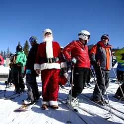 Lambert Veenstra dresses as Santa Claus and chats with skiers and snowboarders in the lift line during opening day at Brighton Resort on Friday, Nov. 25, 2016. With recent snowfall combined with extensive snowmaking, Brighton has a base averaging between 10-20 inches on 3 runs serviced by 2 lifts.  Veenstra has been skiing at Brighton for more than 55 years and can remember when day passes were under $3.00.