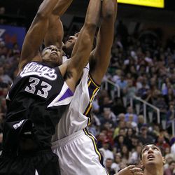 Derrick Favors, of Utah, at back, pulls in a rebound over Hassan Whiteside of Sacramento as the Sacramento Kings face the Utah Jazz in NBA basketball in Salt Lake City, Friday, March 30, 2012. Enes Kanter of Utah is at lower right.