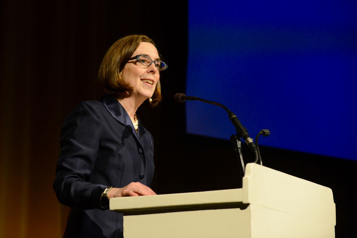 Oregon Governor Kate Brown stands at a podium