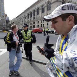Boston police ask people to leave the area in Copley Plaza in the aftermath of two blasts which exploded near the finish line of the Boston Marathon in Boston Monday, April 15, 2013.