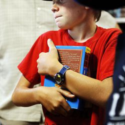 Liam Doornbos holds a book he is waiting to buy at The King's English Bookshop in Salt Lake City on Wednesday, Aug. 23, 2017.