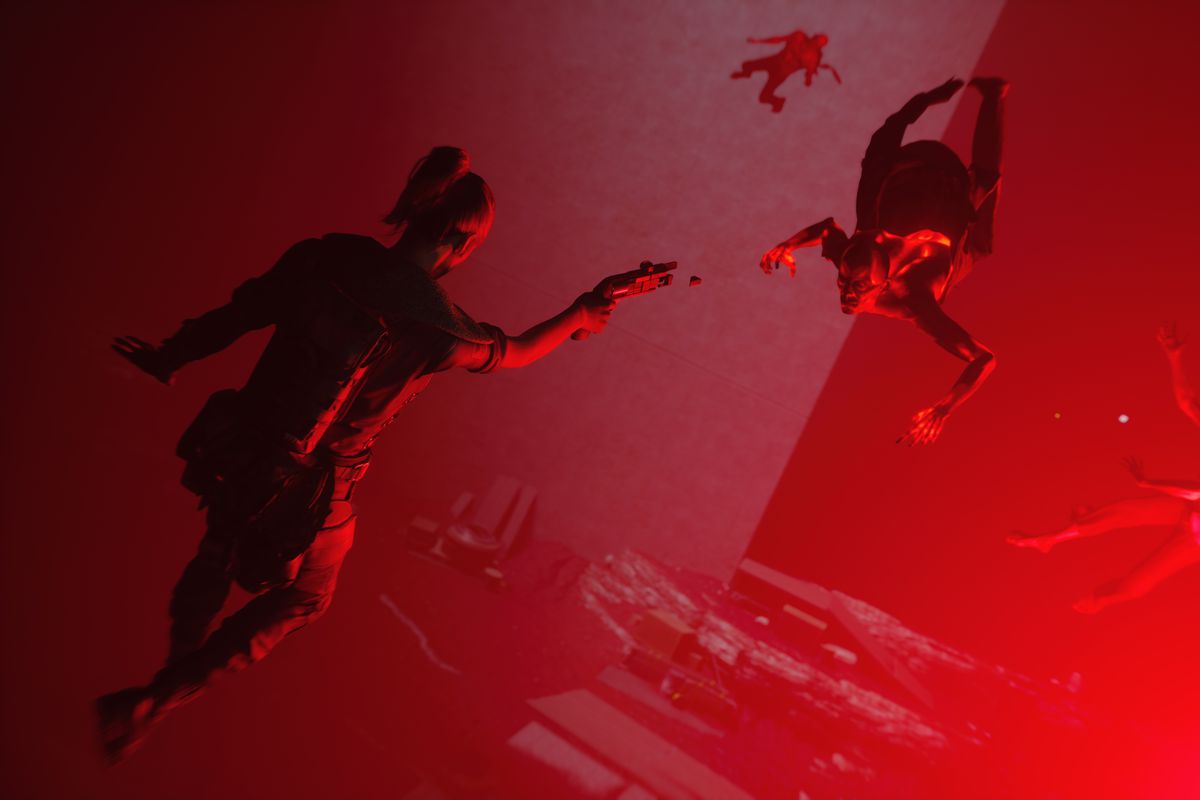 a woman floating in the air in a red room aims a gun at a monster in Control