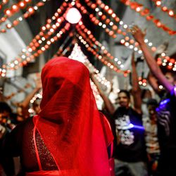  In this Tuesday, April 16, 2013 photo, an Egyptian bride dances at a bachelor party in Cairo, Egypt. Egypt's economy has been hard hit by the two years of turmoil that followed the ouster of longtime President Hosni Mubarak. Half of the country's 85 million people live at or below the poverty line of $2 a day and rely on government subsidies of wheat and fuel for survival.(AP Photo/Eman Helal)